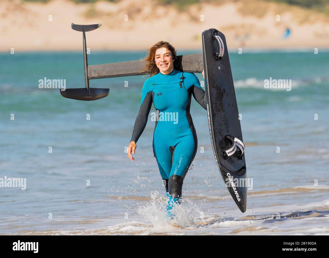 Woman with a kitesurfing racing foil board. Stock Photo