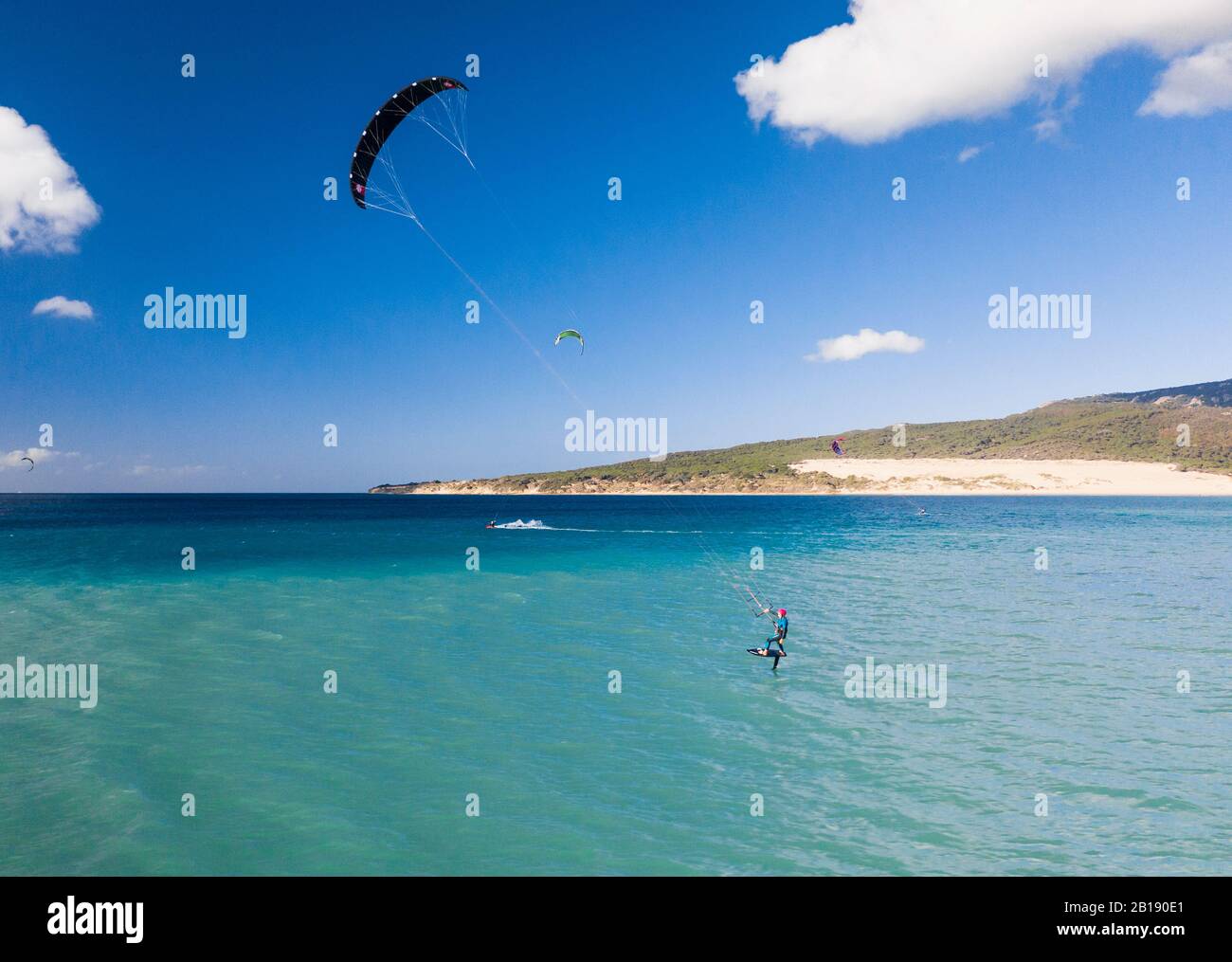 Woman riding a kite foil at Valdevaqueros, Tarifa, Costa de la Luz, Cadiz, Andalusia, Spain. Stock Photo