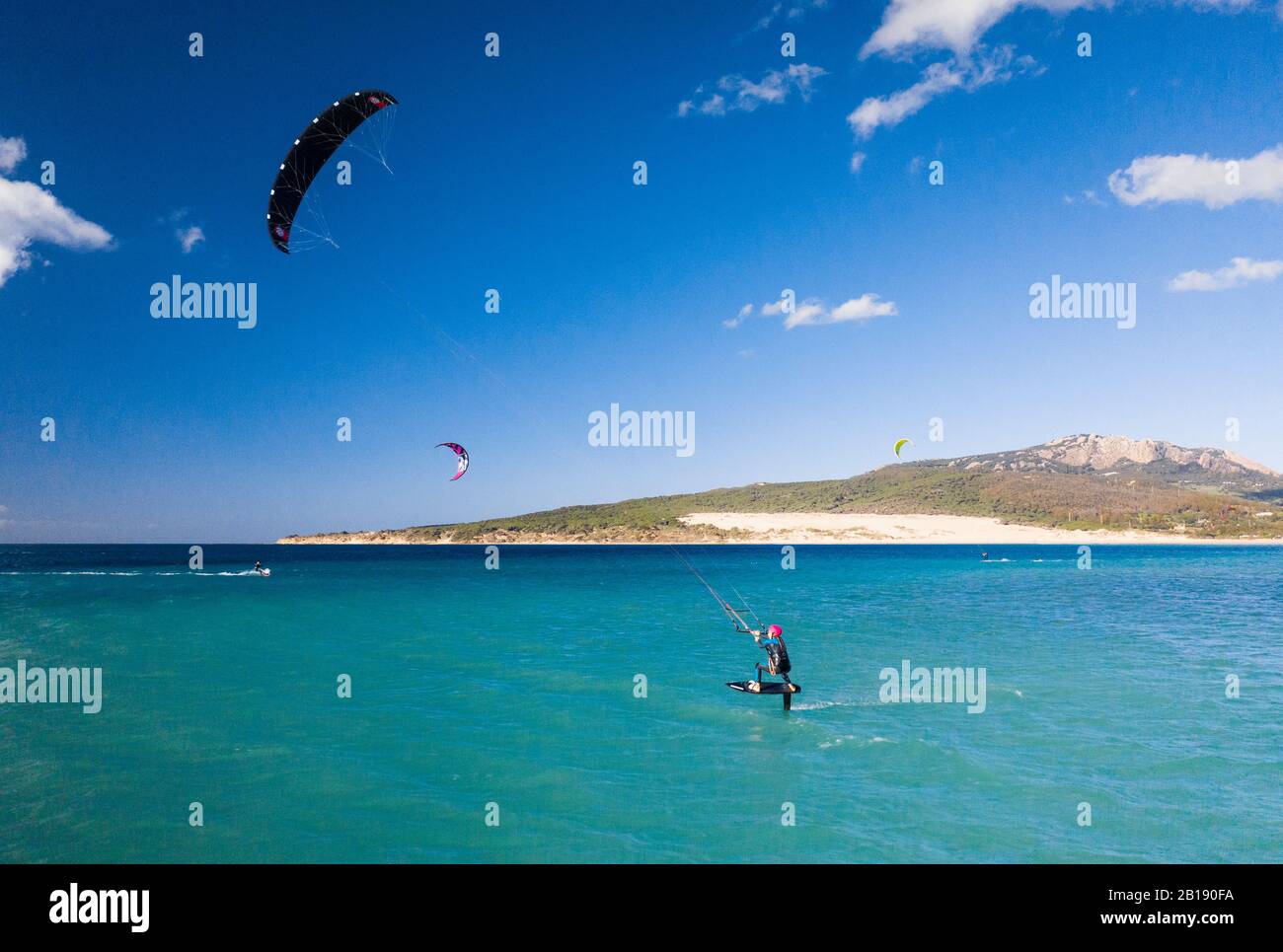 Woman riding a kite foil at Valdevaqueros, Tarifa, Costa de la Luz, Cadiz, Andalusia, Spain. Stock Photo
