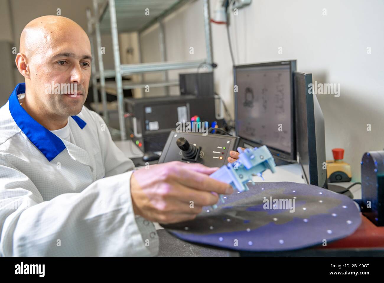 Quality engineer examines a sample scanned with a laser on a 3d scan in