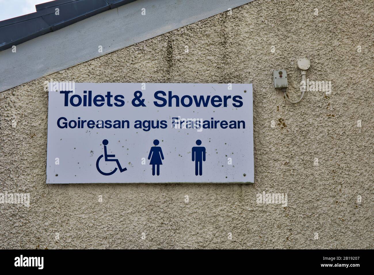 Public toilets and showers sign in English and Gaelic on the island of Scalpay, Isle of Harris, Outer Hebrides, Scotland Stock Photo