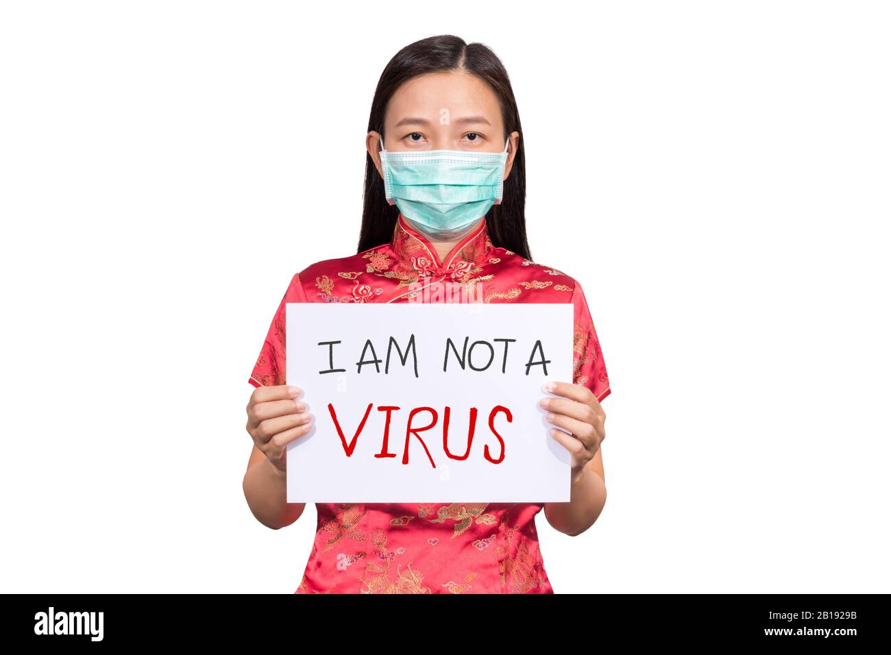 Asian woman in Chinese costume wear a hygienic mask holding sign I am not a VIRUS for anti racism , bullying and hate in the outbreak situation of Cor Stock Photo