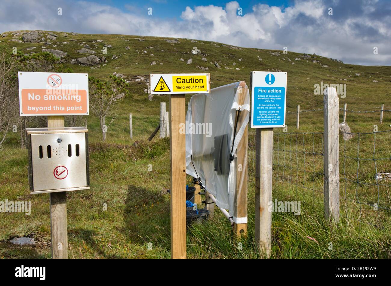Fire action no smoking warning signs and fire paddle beater, Isle of Lewis and Harris, Outer Hebrides, Scotland Stock Photo