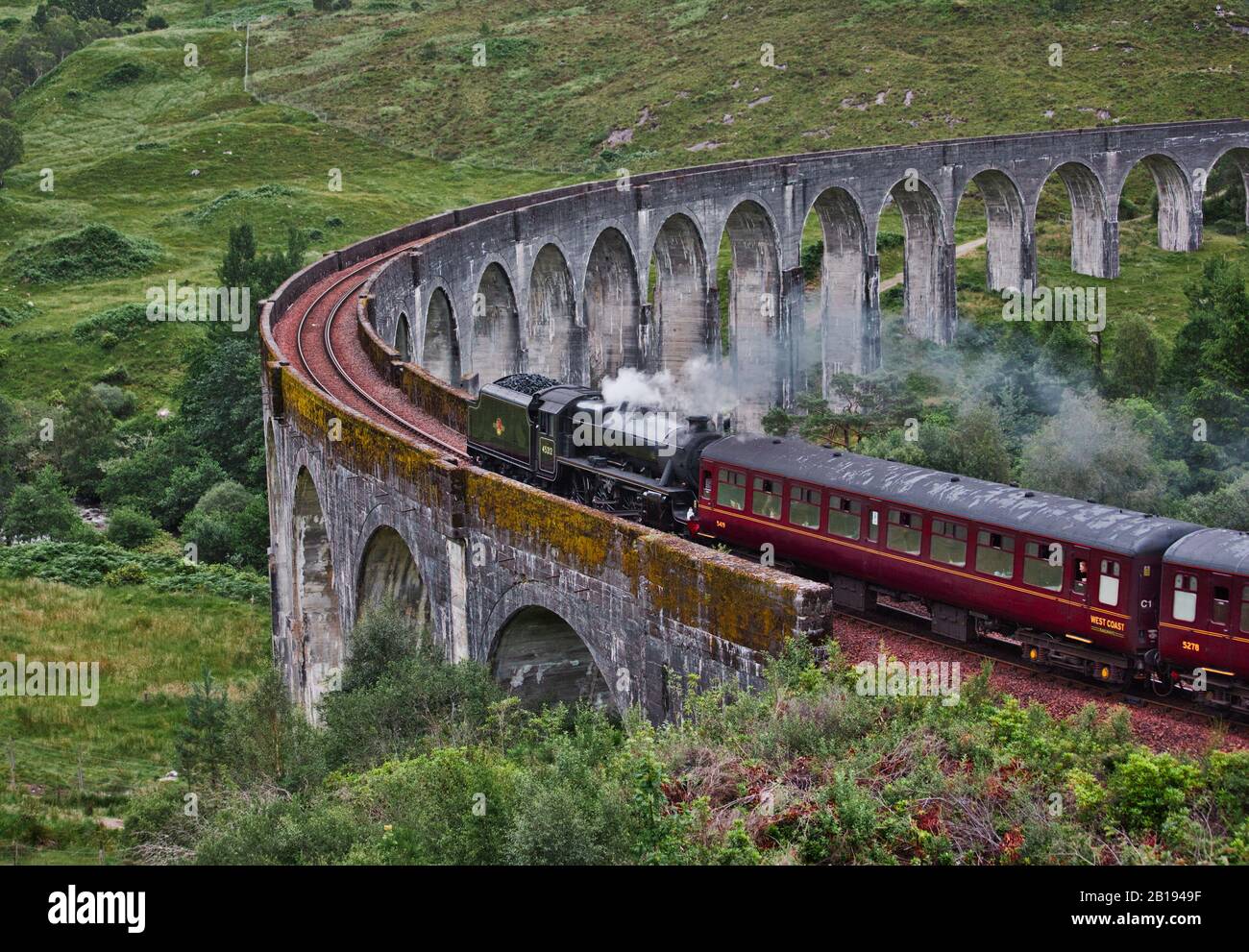 Jacobite steam train blowing steam as it crosses the Glenfinnan Viaduct, Glenfinnan, Inverness-shire, Scotland Stock Photo