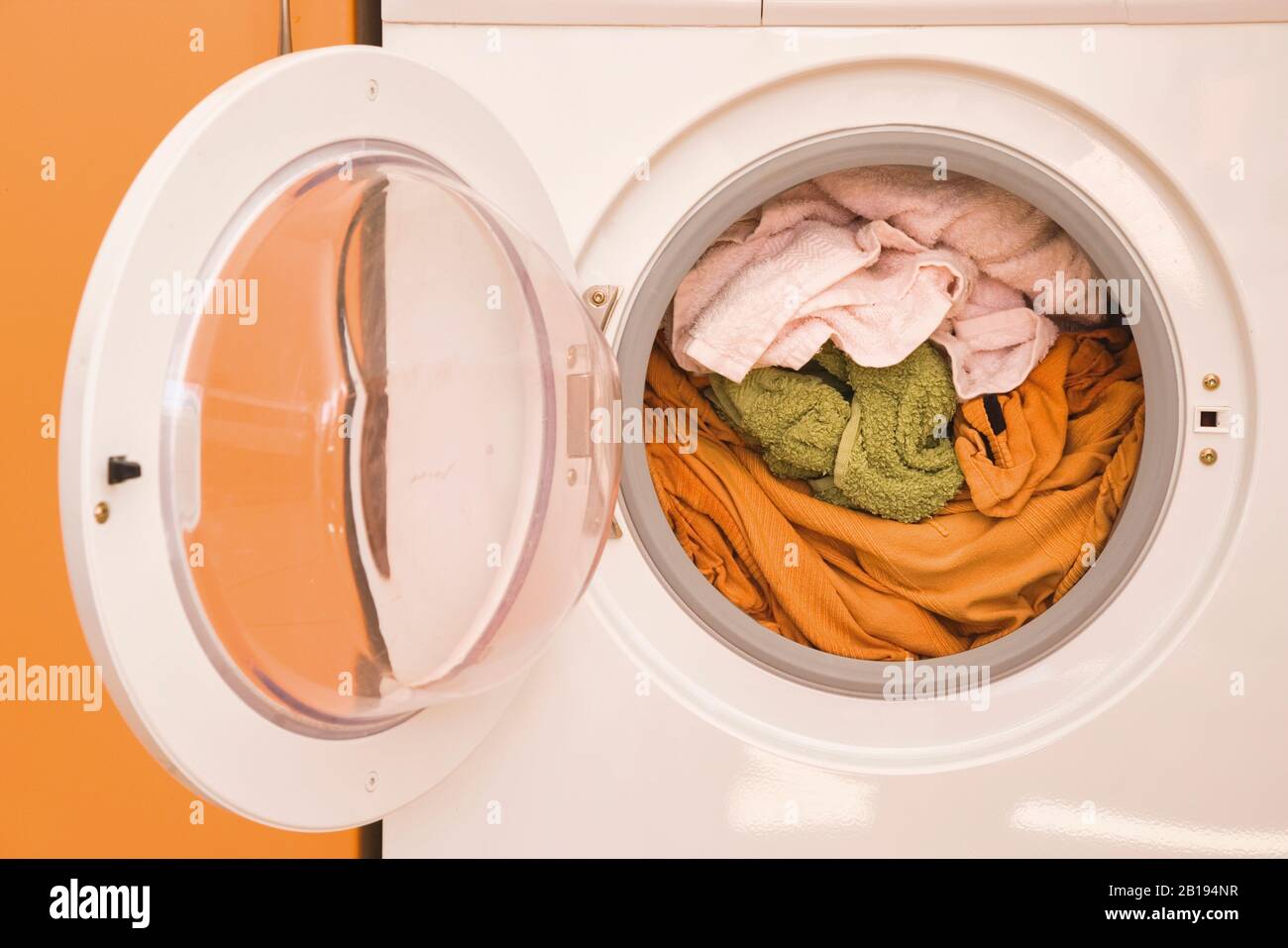 Washing machine full of dirty washing Stock Photo