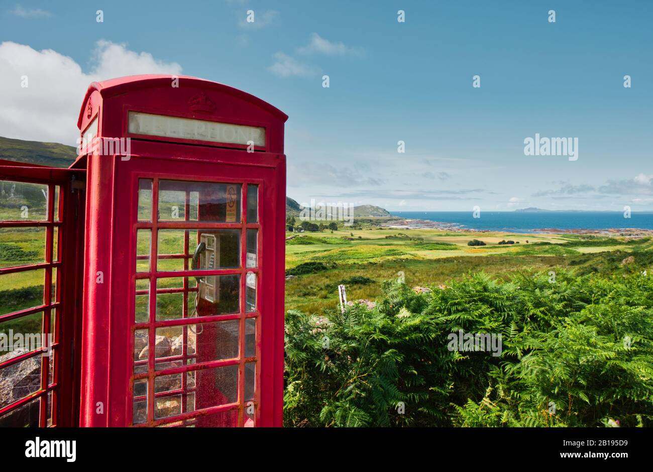 Iconic red remote British telephone box and view of the Atlantic Ocean, Ardnamurchan peninsula, Lochaber, Highland, Scotland Stock Photo