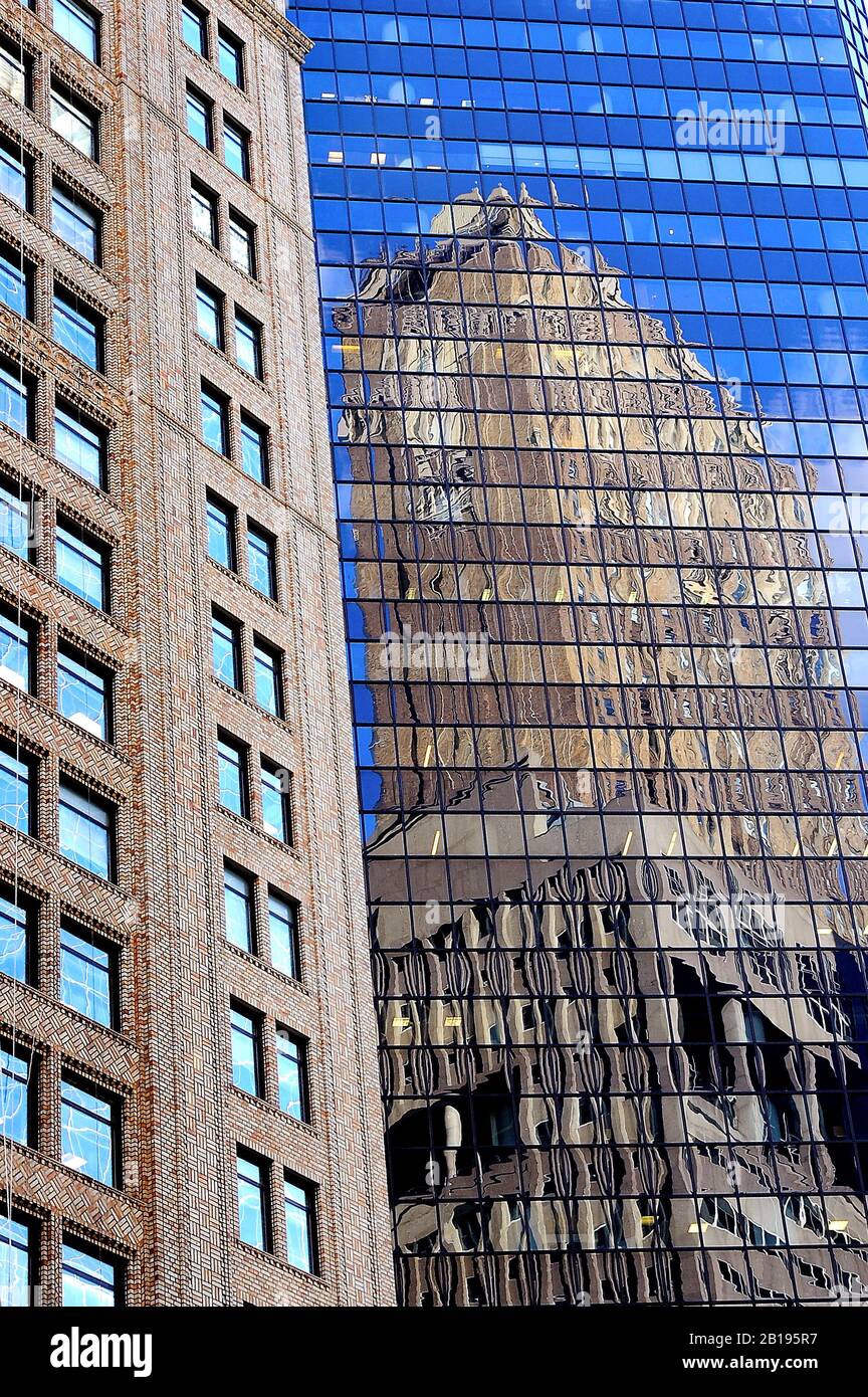 All glass skyscraper towers in New York City with reflections of other