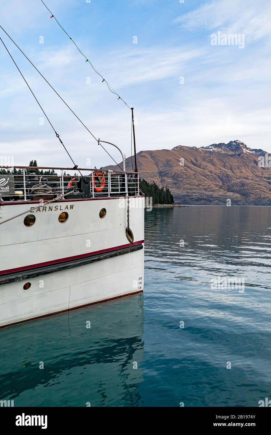 The bow of the Edwardian Steamer TSS Earnslaw in Queenstown, New Zealand with its destination, Walter's Peak, in the distance Stock Photo