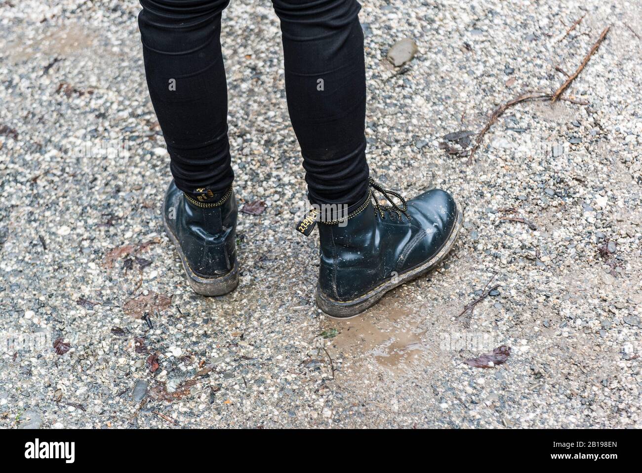 A person wearing Dr Martens black leather boots Stock Photo - Alamy