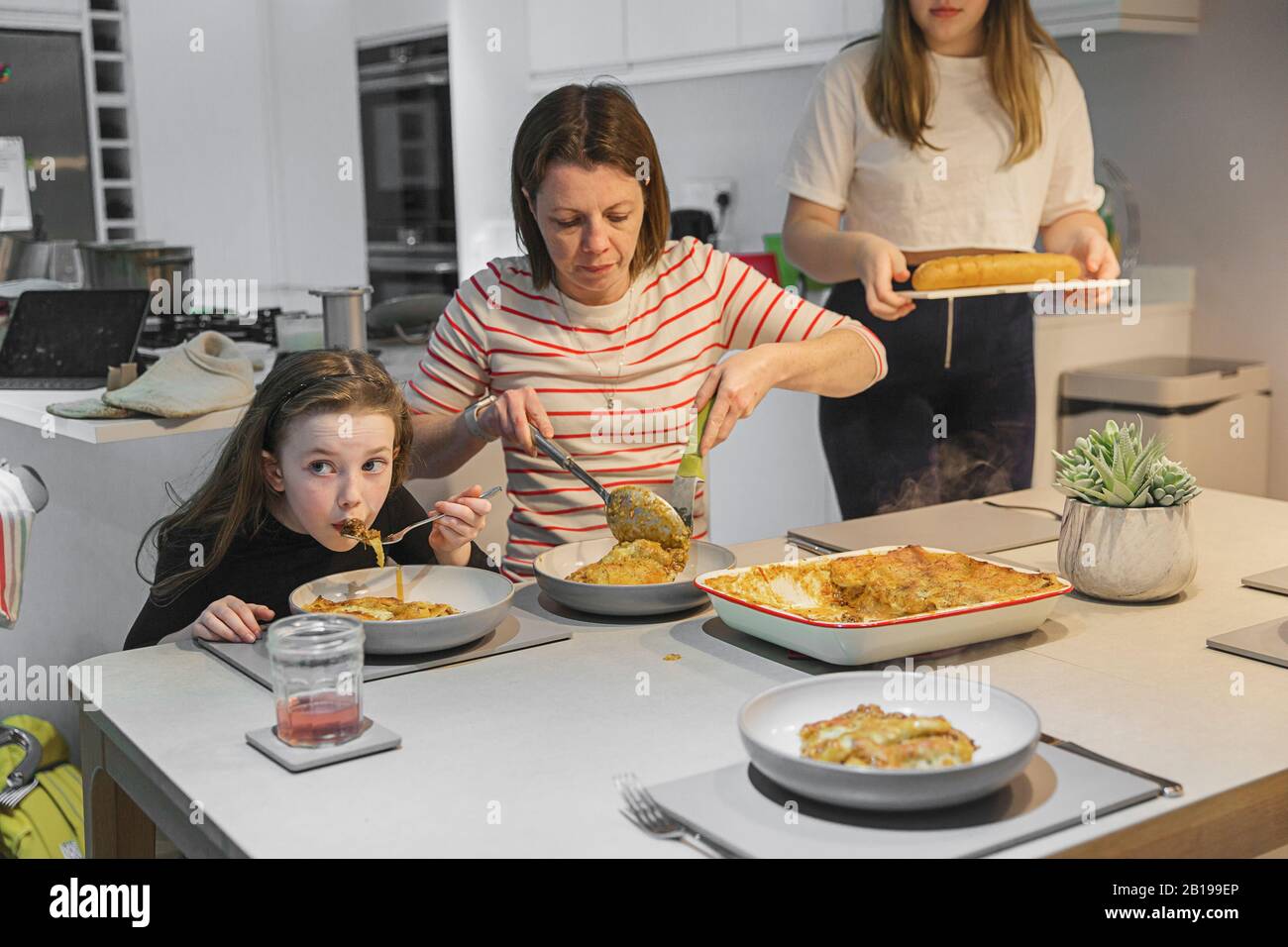 Family mealtime - lasagne Stock Photo