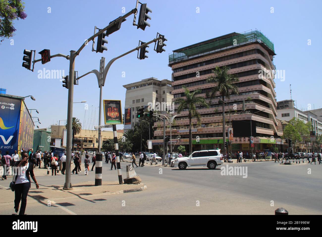Nairobi, Kenya - January 17, 2015: road in the city center with pedestrians, cars and traffic lights Stock Photo