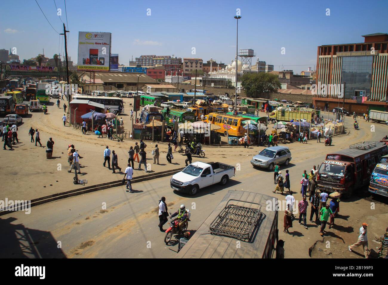 Nairobi, Kenya - January 17, 2015: A busy street full of public transport, buses, cars, motorcycles and pedestrians. View from above Stock Photo