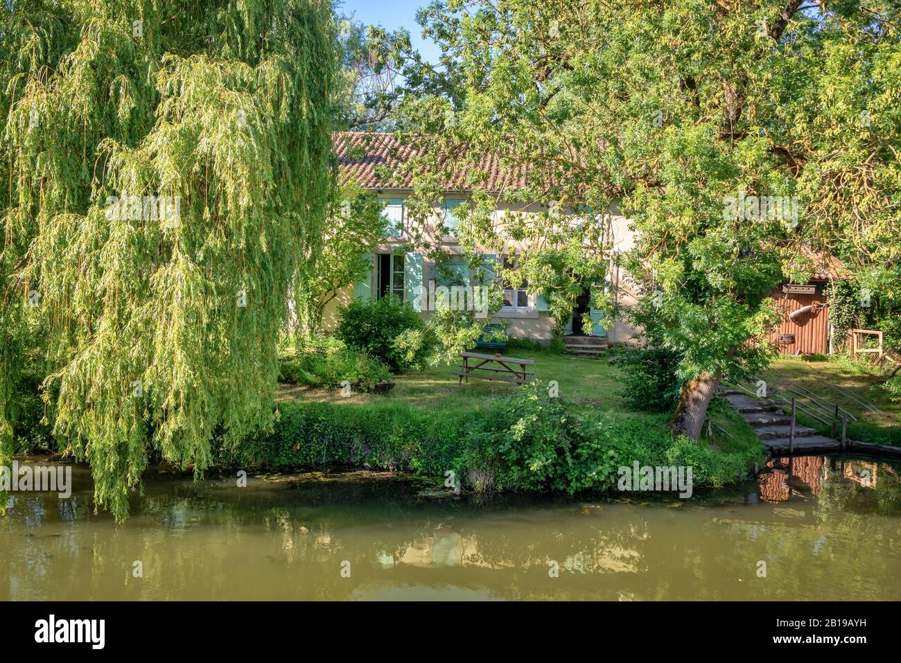 Typical house with a boat pier in the Marais Poitevin, France Stock Photo