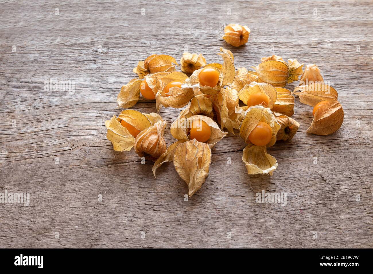 Ripe yellow physalis on wooden background, close up Stock Photo
