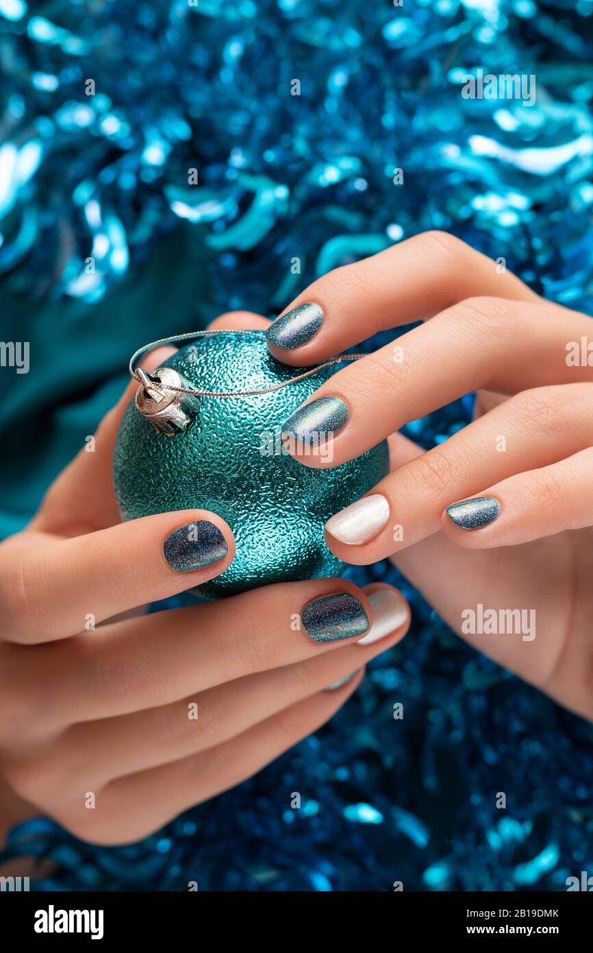 Beautiful female hand with blue christmas nail design Stock Photo - Alamy