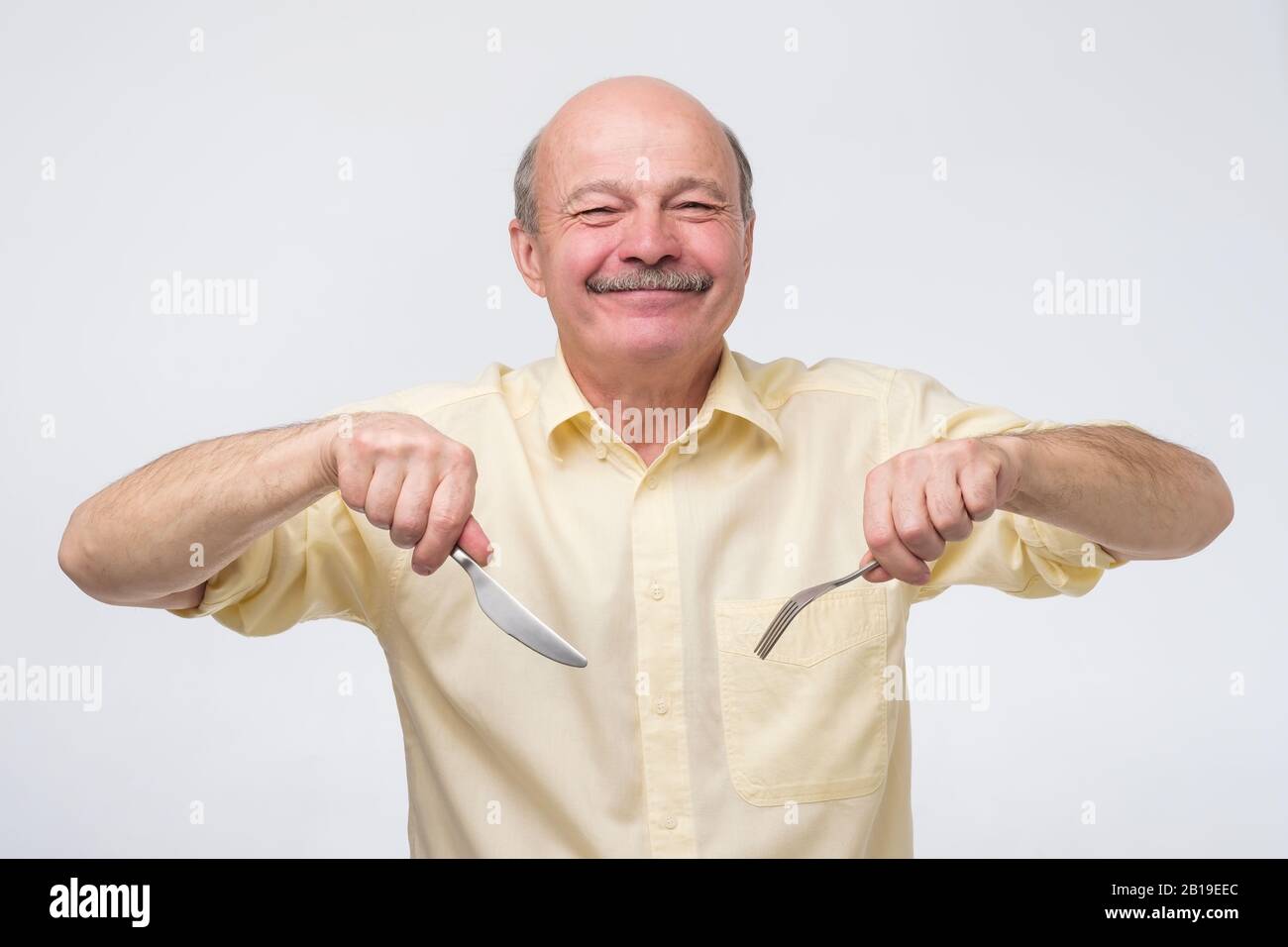 Man holding knife and fork hi-res stock photography and images - Alamy