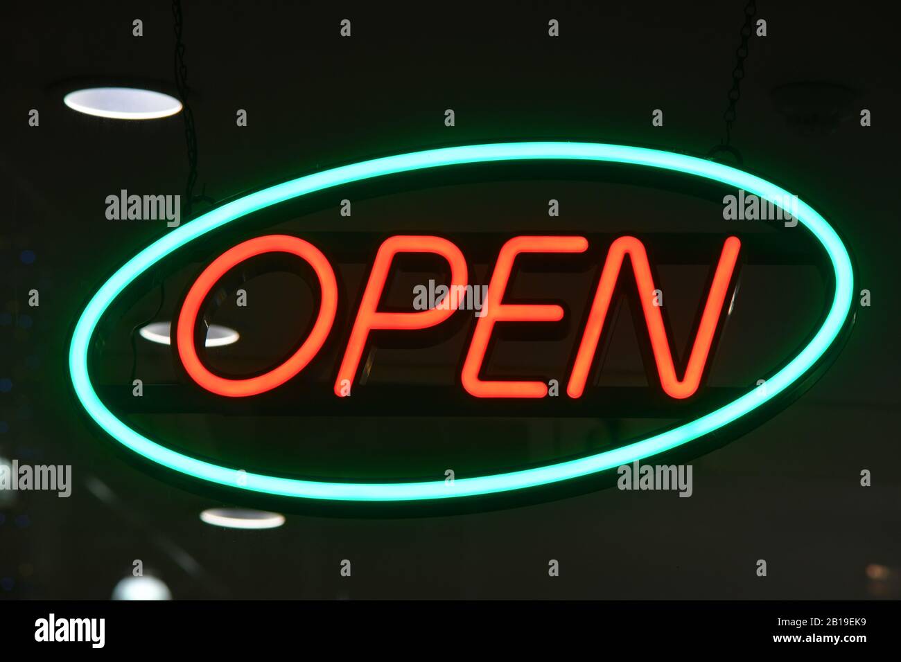 neon open sign in shop window at night Stock Photo