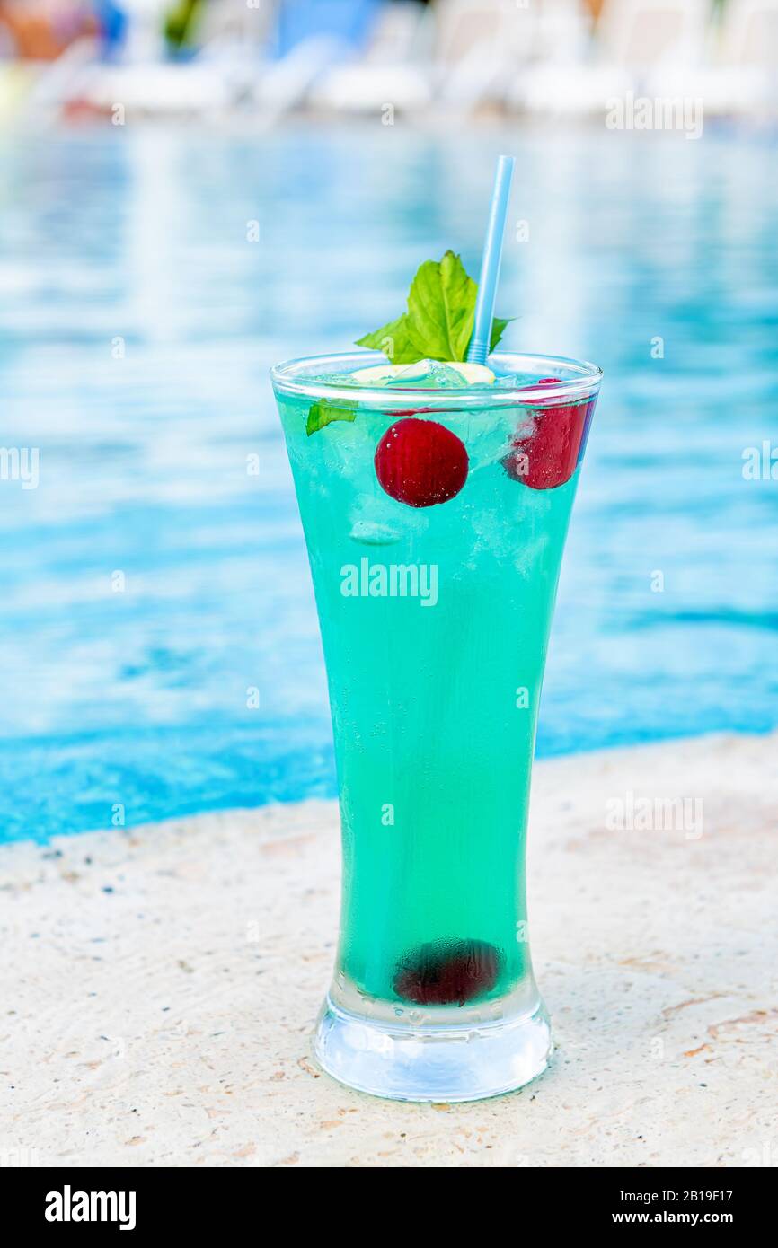 Refreshing cocktail near swimming pool, tclose up. Stock Photo