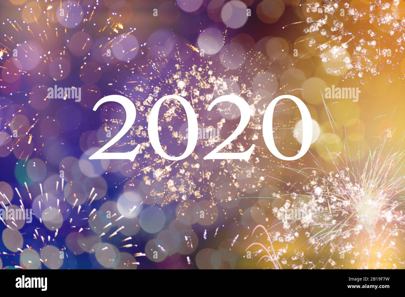 Happy new year 2020 written with Sparkle fireworks and bokeh Stock Photo