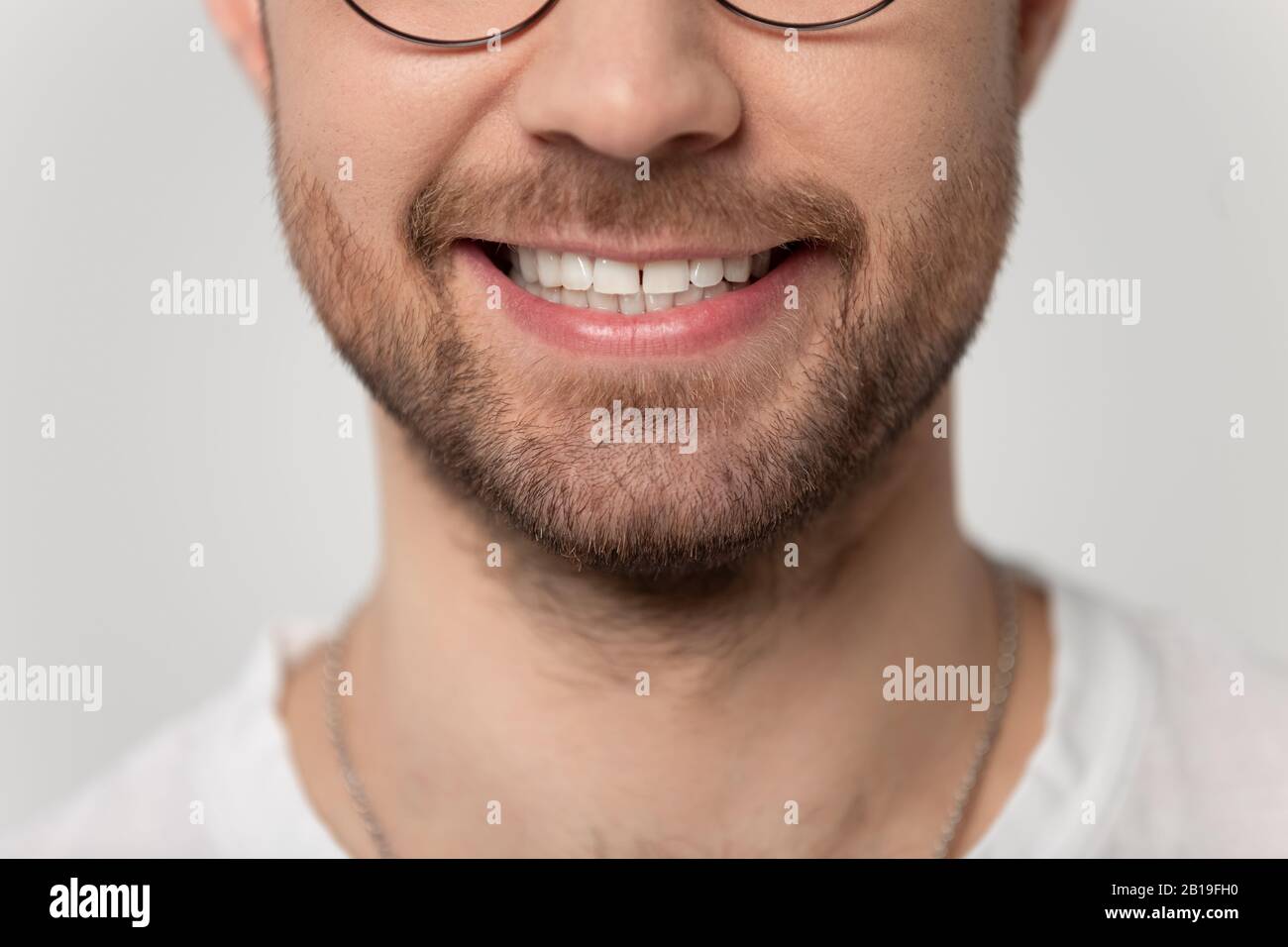 Close up cropped image wide toothy smiling young bearded man. Stock Photo
