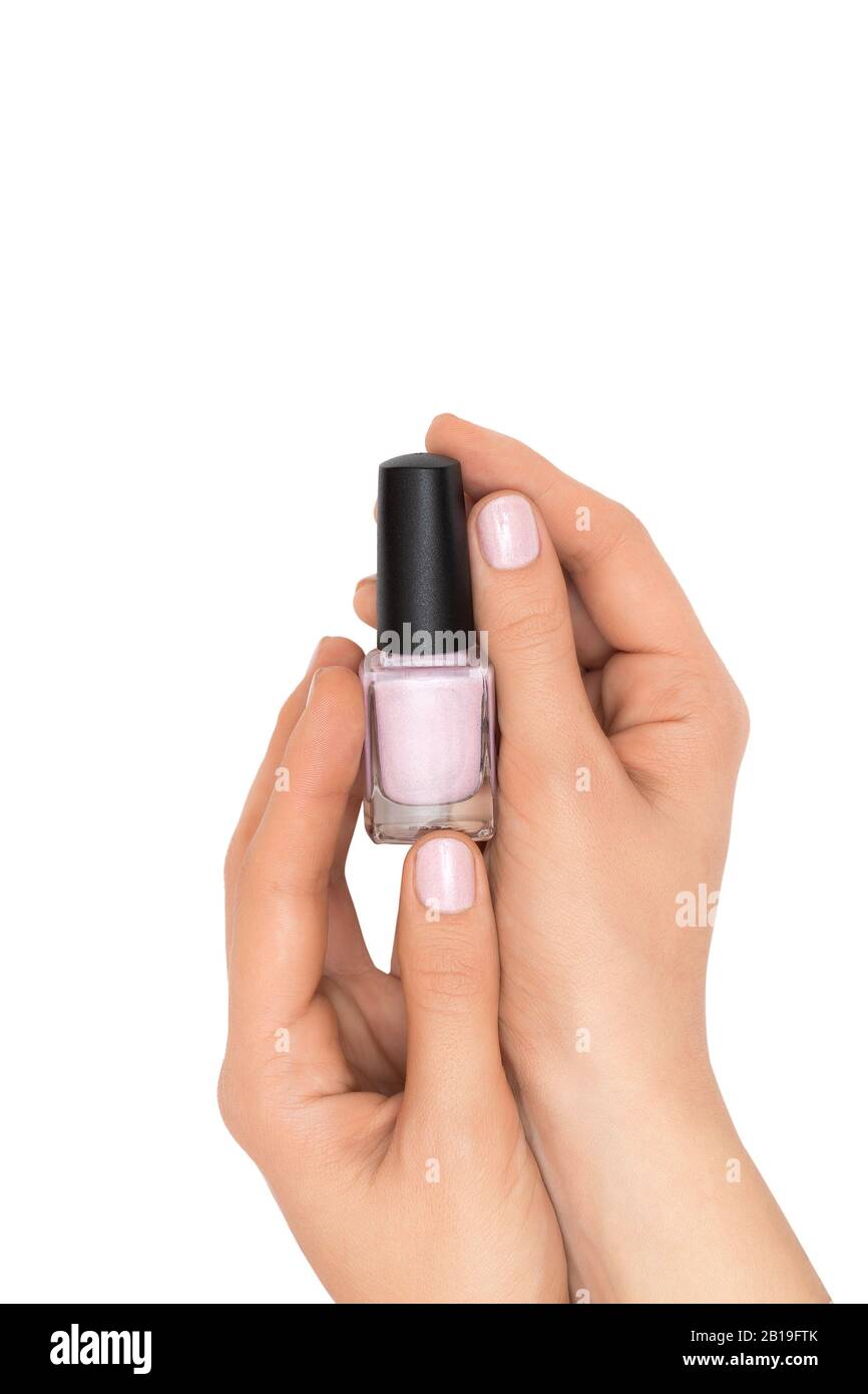 Female hands holding nail polish bottle on white background Stock Photo