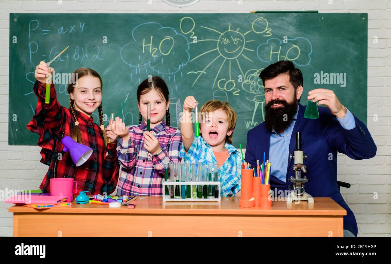 Looking at future of science. happy children teacher. back to school. experimenting with chemicals or microscope at laboratory. biology education. Microscope. Biology school laboratory equipment. Stock Photo