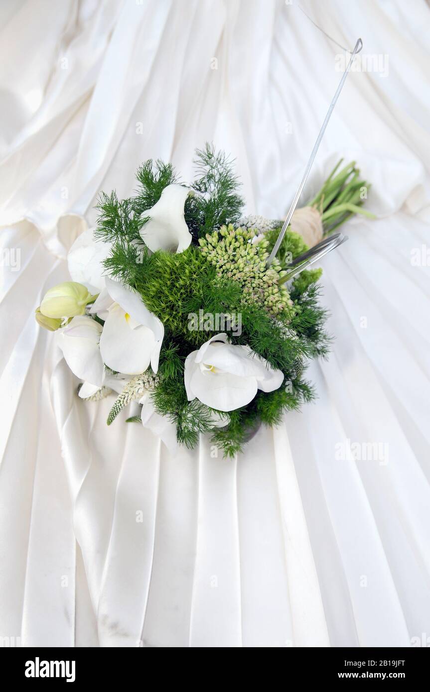 Beautiful wedding bouquet with flowers of white calla lilies. Zantedeschia aethiopica. Stock Photo