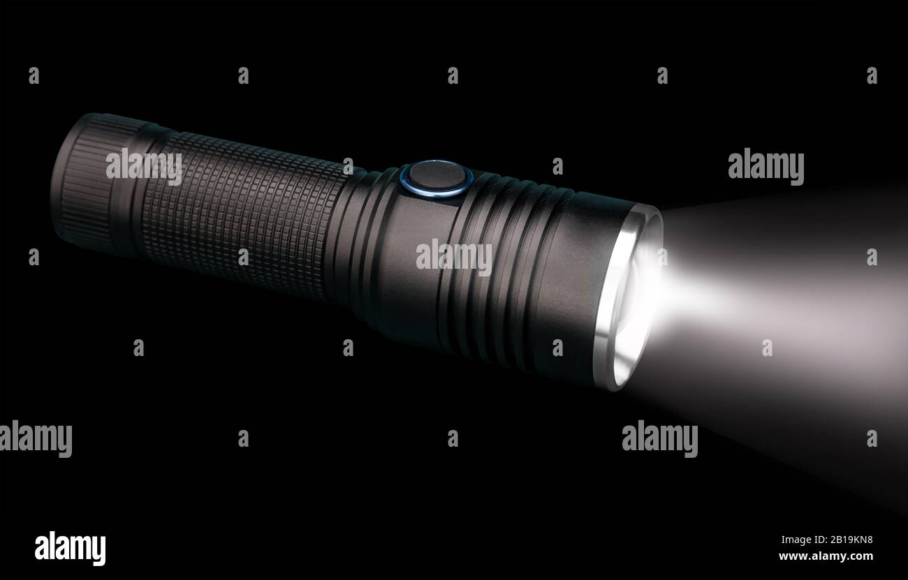 Battery powered flashlight on black background with copy space Stock Photo