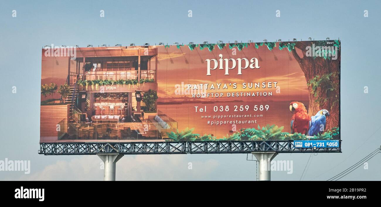 Large billboard advertising a restaurant by the ocean. Stock Photo