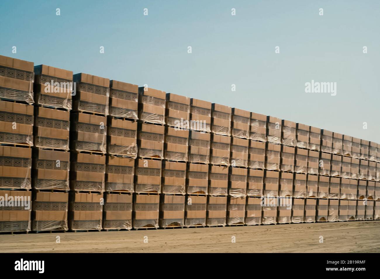 Bricks are stored in an openair warehouse. Red brick in pallets Stock