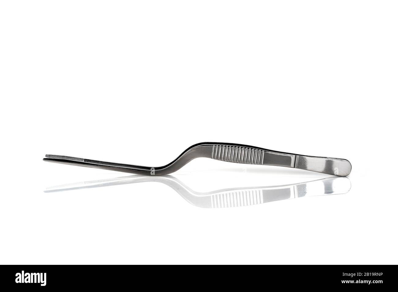 a pair of metal curved tweezers on a white background Stock Photo