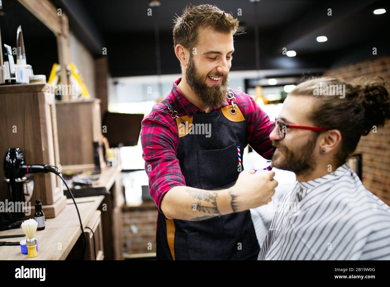 Client during beard and moustache grooming in barber shop Stock Photo Alamy