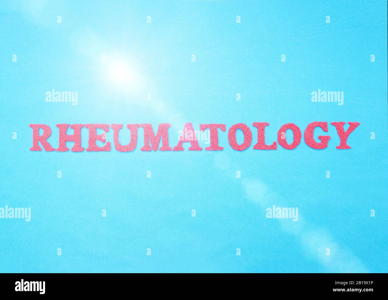Word Rheumatology in red letters on a blue background. The concept of a section of medicine that treats inflammation and diseases of the joints, arthr Stock Photo
