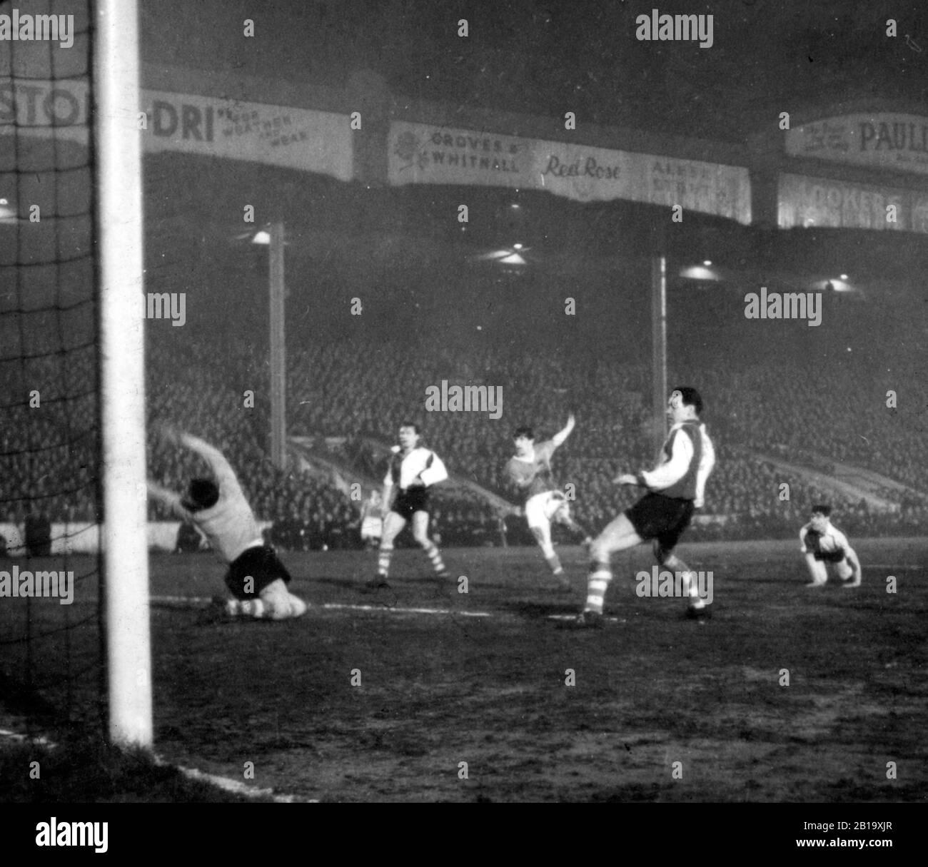 Manchester United inside left Dennis Viollet (centre, arm raised) scores his team's first goal in the European Cup match against Athletic Bilbao at Maine Road, Manchester. Athletic Bilbao's goalkeeper Carmelo Cedrun is on his knees arms outstretched. *SCANNED FROM CONTACT AS NEG IS CORRUPT Stock Photo