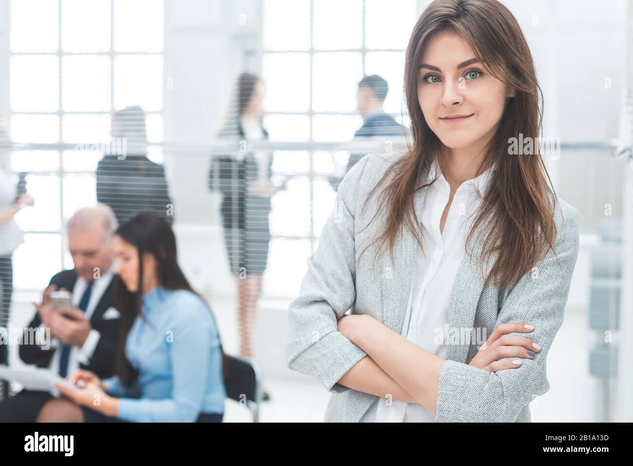 young business woman standing in a modern office Stock Photo - Alamy
