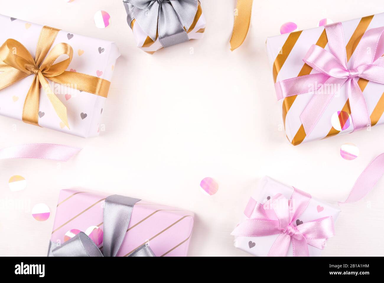 Several gift boxes with bows and confetti on a white background. Stock Photo