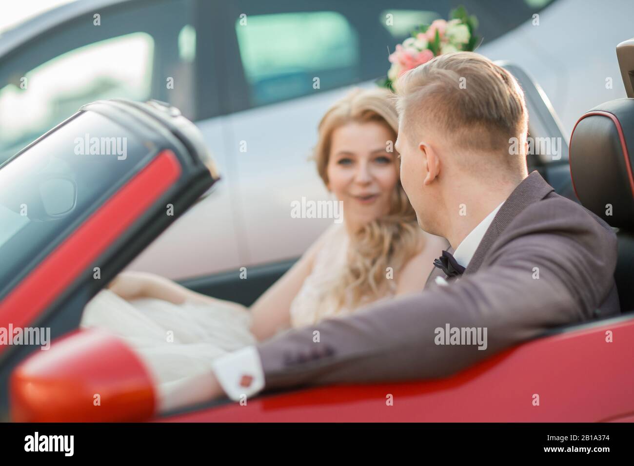 happy bride and groom sitting in a luxury car Stock Photo - Alamy
