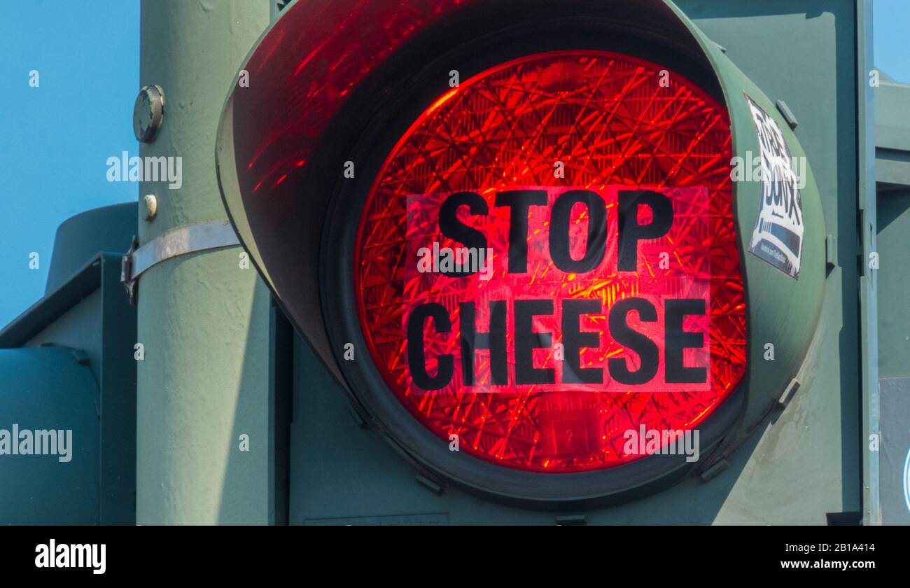 'stop cheese', text on transparent film attached to red traffic light Stock Photo