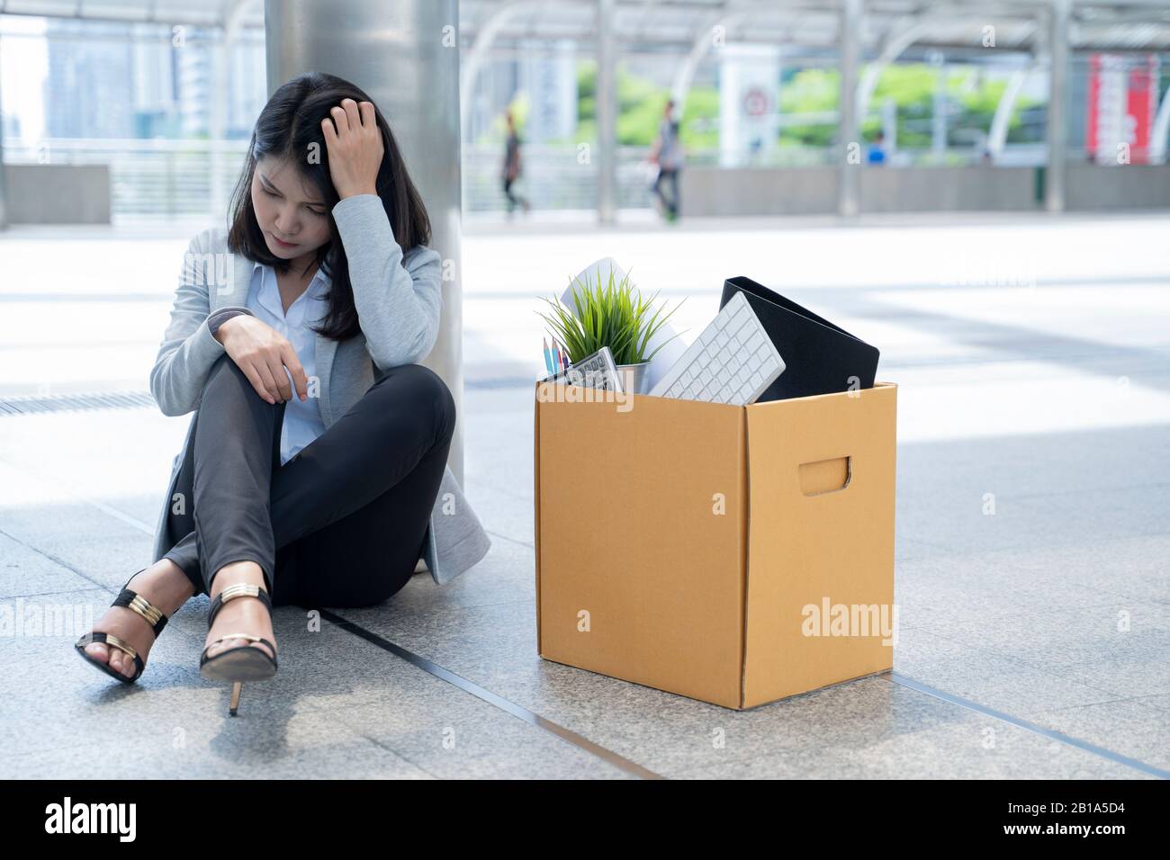 An unemployed business woman sitting in stress. Stock Photo