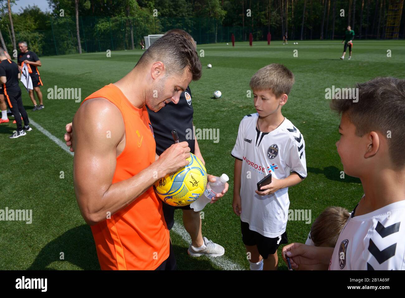 Football player Junior Moraes, Shakhtar soccer team, signing autographs to children. August 5, 2019. Kiev, Ukraine Stock Photo