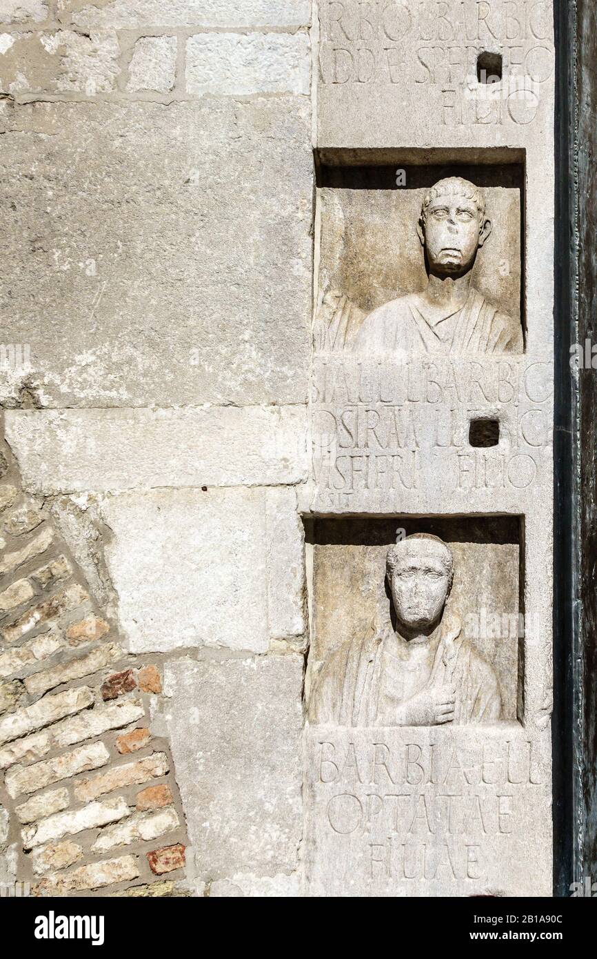 Trieste, Italy. The 14c Cathedral of San Giusto has many pieces of Roman funerary sculpture randomly built into the facade Stock Photo