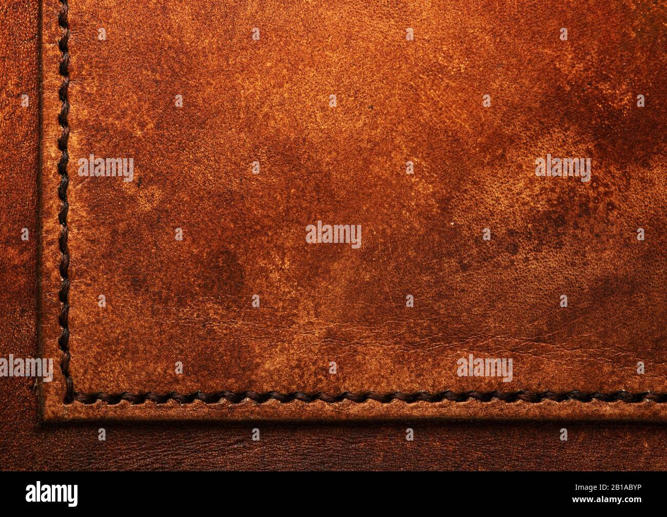 Hand stitched leather showing dark brown waxed thread closeup full frame macro on vegetable tanned top grain Stock Photo