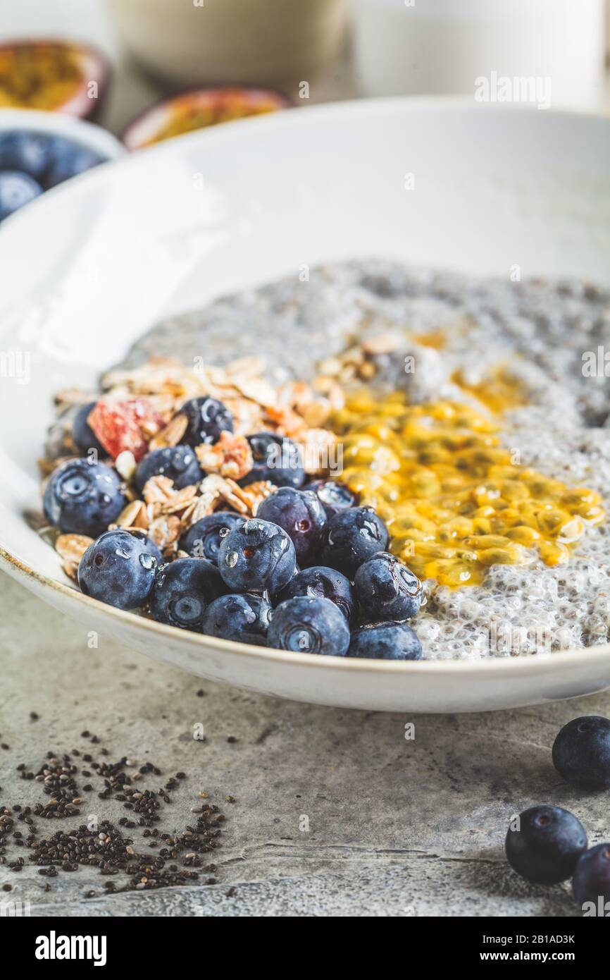 Chia pudding bowl with blueberries, passion fruit and muesli. Healthy