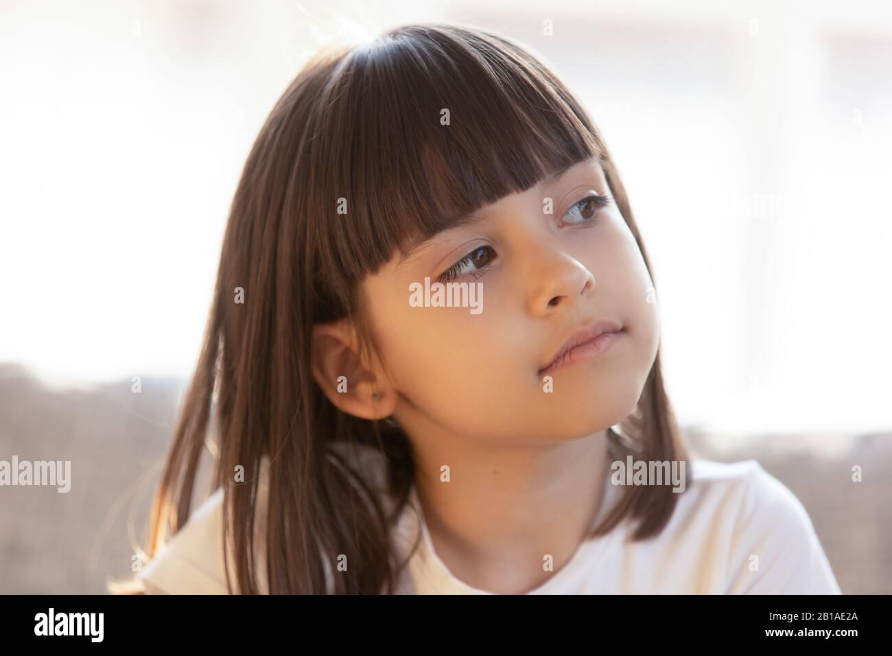 Little girl look in distance dreaming or thinking Stock Photo