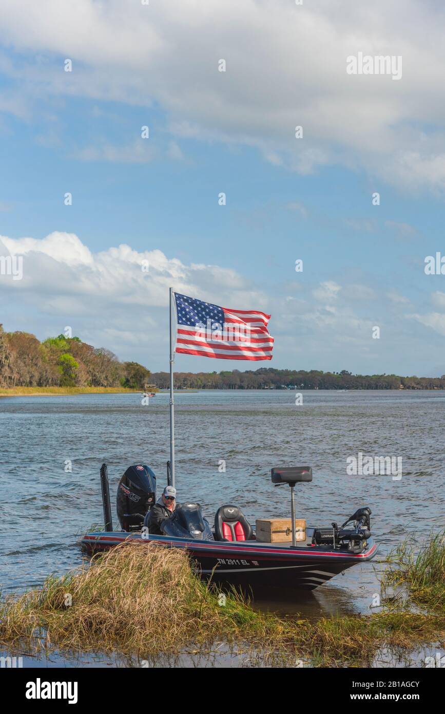 Bass Boat displaying the American Flag on the Chain of Lakes in Leesburg, Florida USA Stock Photo