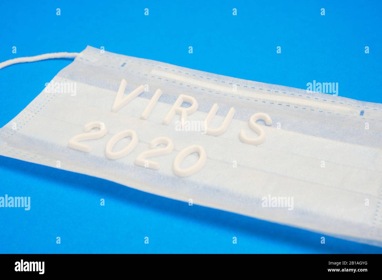 Medical mask for protection and the inscription virus 2020 on a blue ...