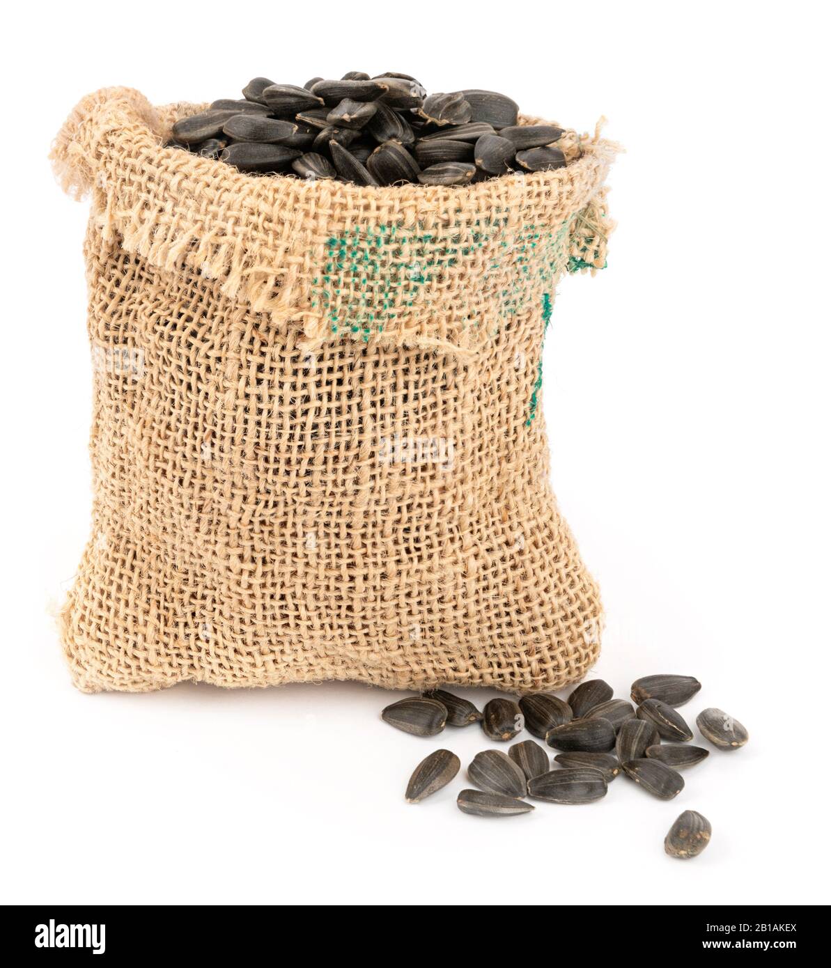 Sunflower seeds in a rustic sack isolated on white background with ...