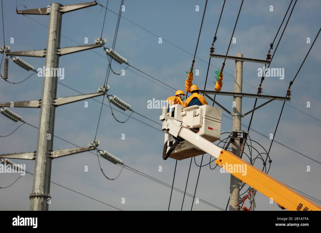 Chinese electricians perform live working on electric transmission lines to secure power supply in Langya District, Chuzhou City, east China's Anhui Province on February 23rd, 2020. (Photo by Song Weixing / Costfoto/Sipa USA) Stock Photo