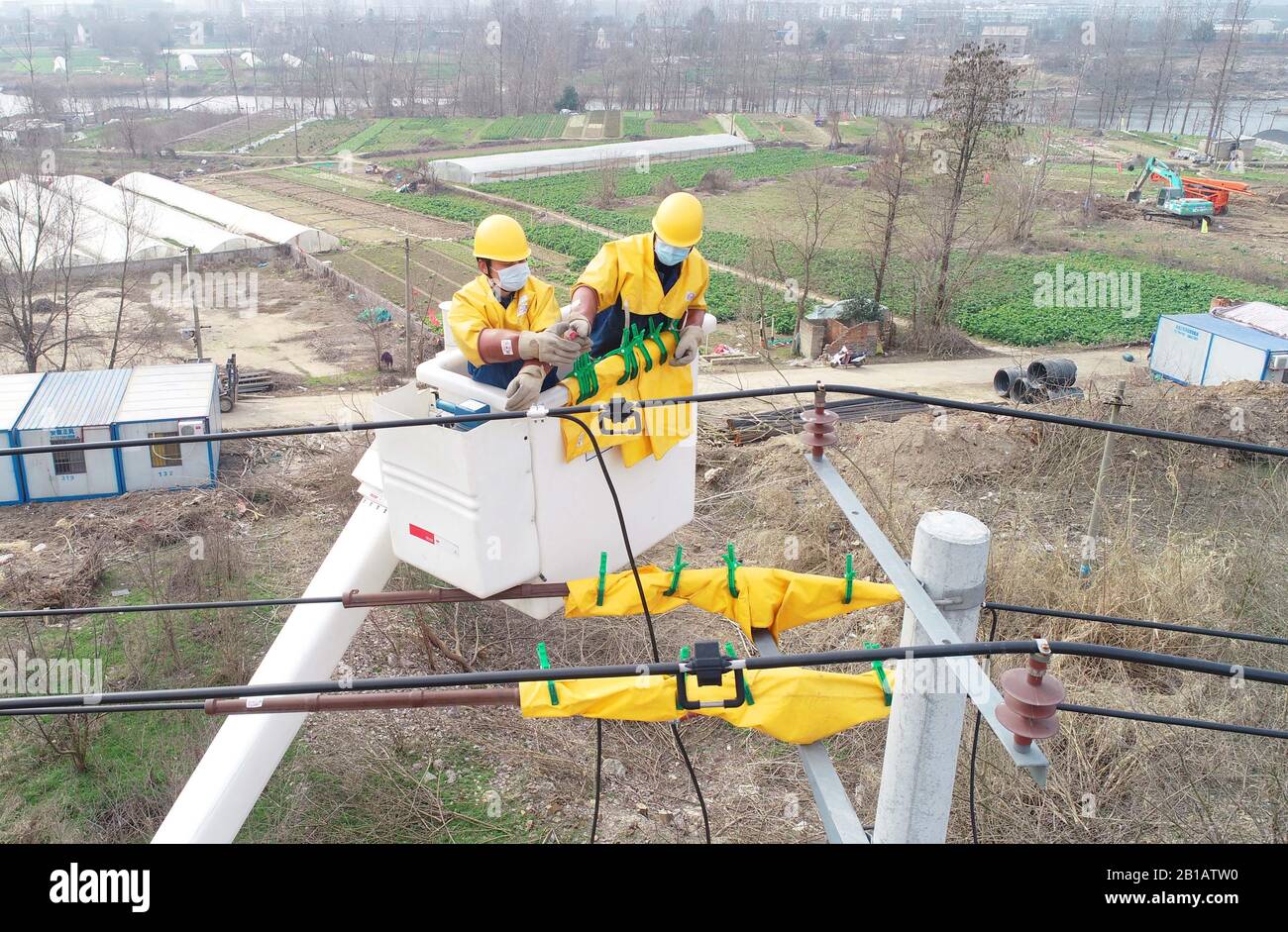 Chinese electricians perform live working on electric transmission lines to secure power supply in Langya District, Chuzhou City, east China's Anhui Province on February 23rd, 2020. (Photo by Song Weixing / Costfoto/Sipa USA) Stock Photo