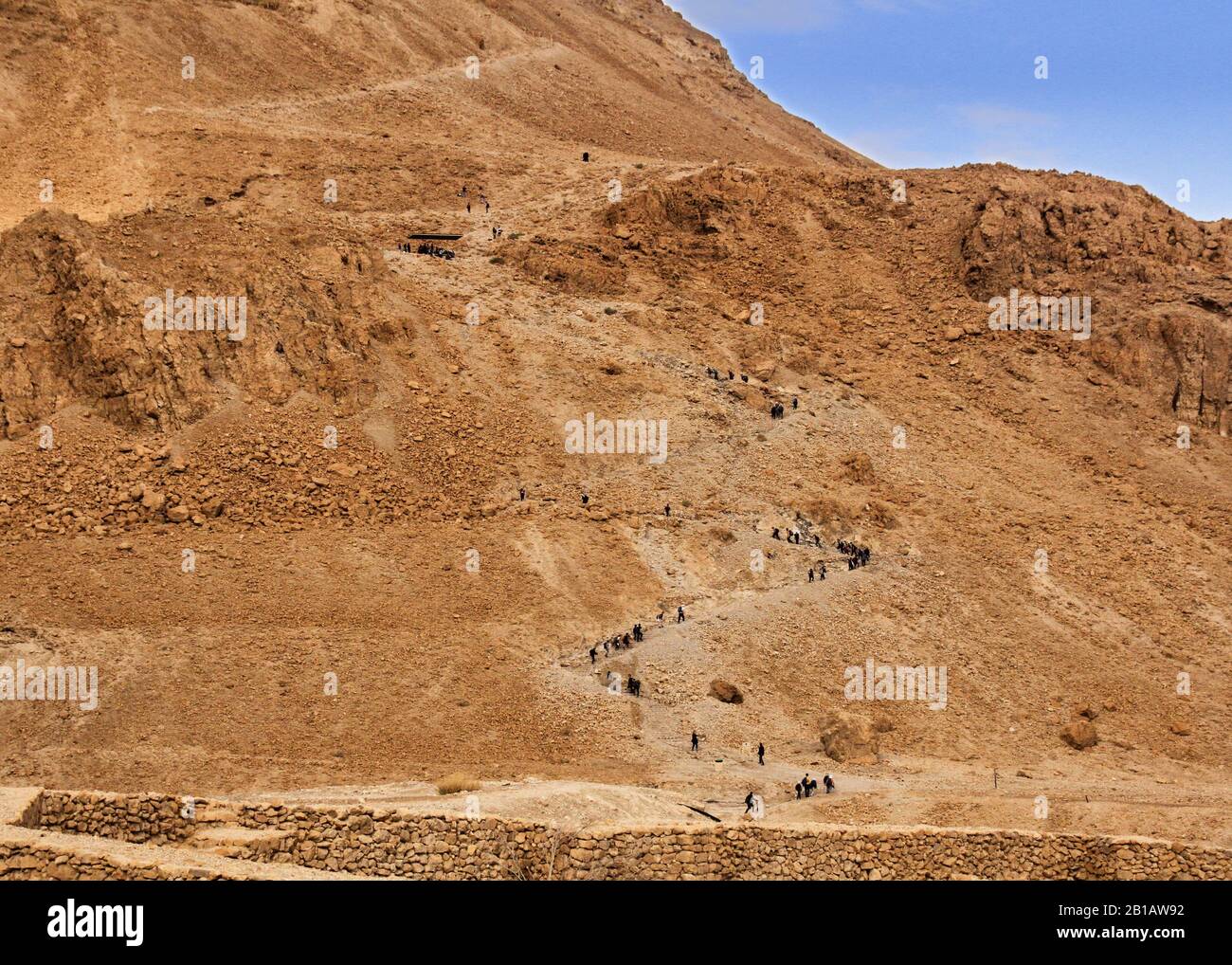 People climb up Masada on the winding path to the plateau. Stock Photo